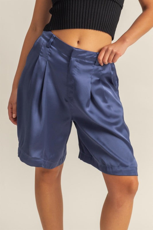 High-waist pleated satin shorts with an elegant and sophisticated design, perfect for chic styling.