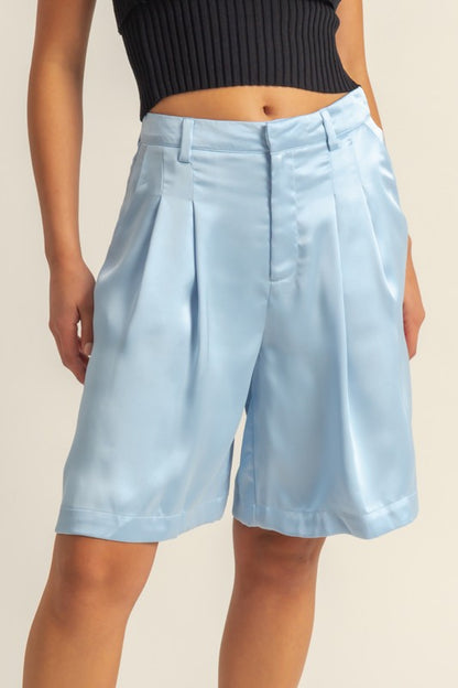 Elegant high-waist pleated satin shorts with a chic silhouette and luxurious finish, perfect for dressy or casual looks.