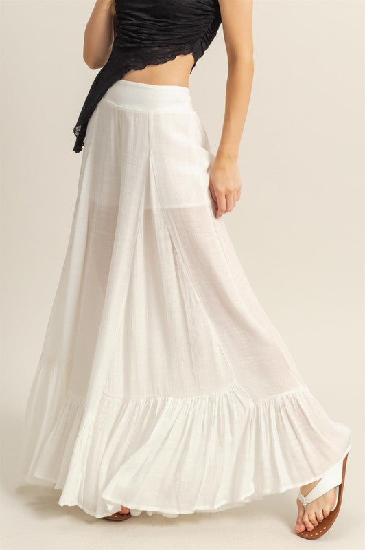 Elegant high-waist flared wide-leg pants with cascading ruffle details, perfect for both casual and formal wear.