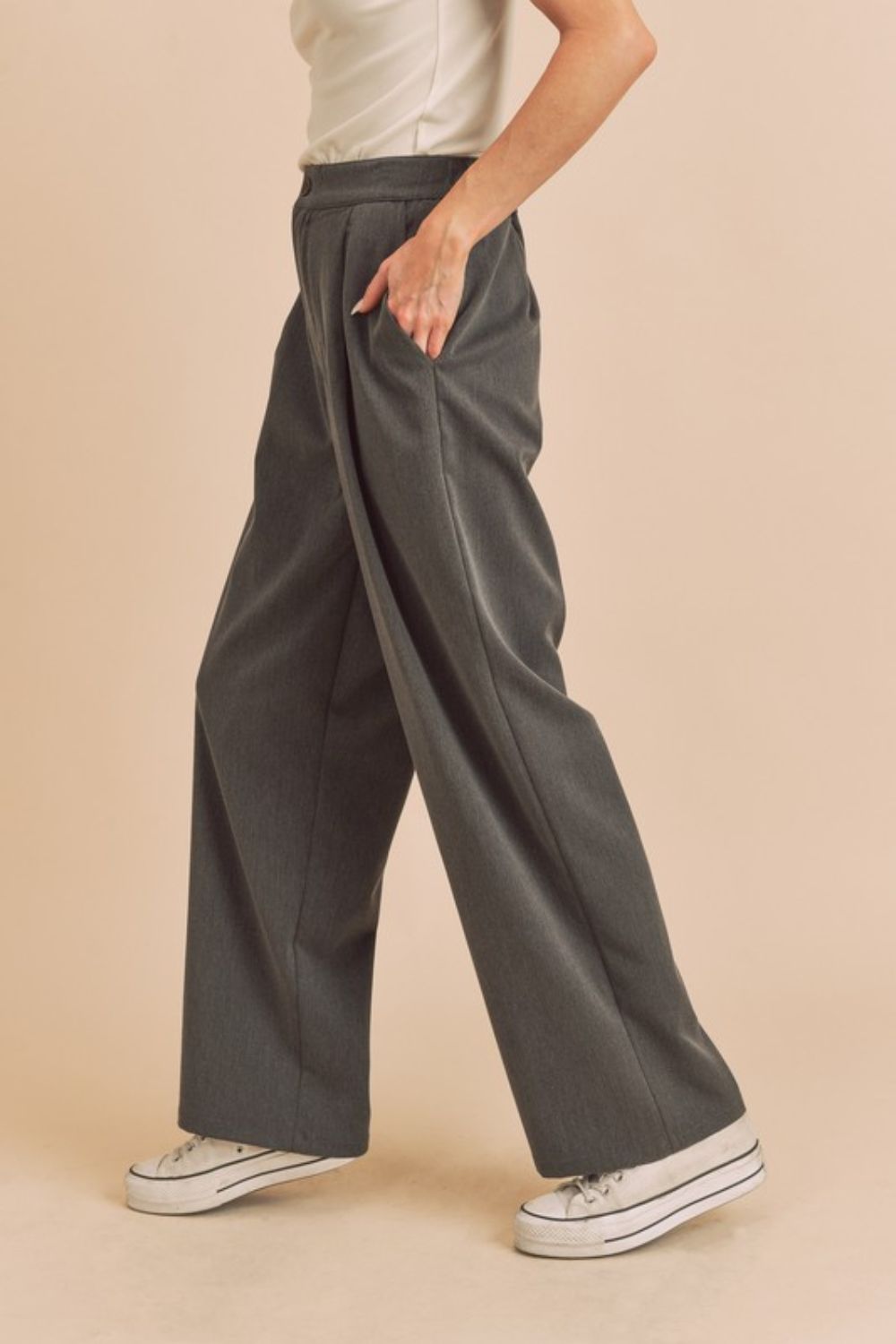 High waist wide leg pants with side pockets in a chic flowy design, offering a flattering and comfortable fit for any occasion.