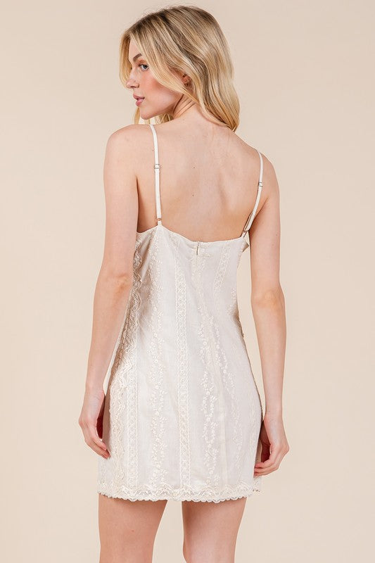 Lace detail adjustable strap mini cami dress with a feminine design and delicate lace accents for a chic and stylish look.