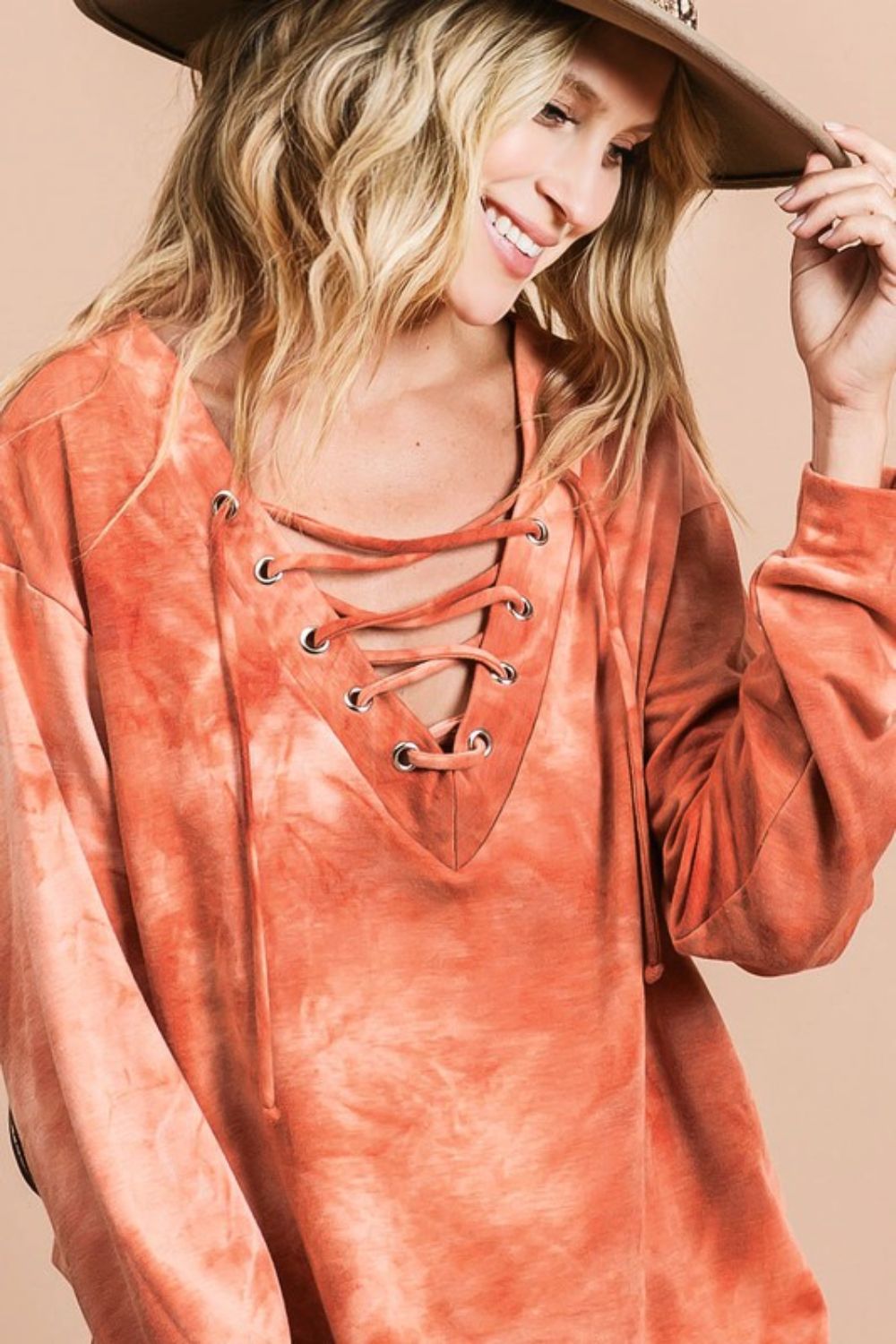 Trendy lace-up tie-dye French terry long sleeve top, perfect for casual and cozy wear.