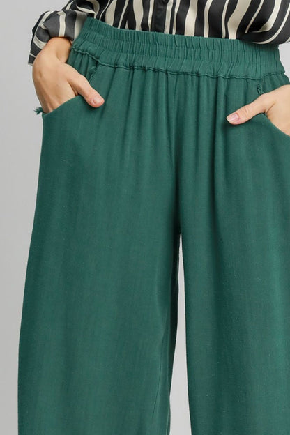 Linen blend wide-leg pants featuring an elastic waistband, breathable fabric, and functional side pockets for a chic and comfortable look.