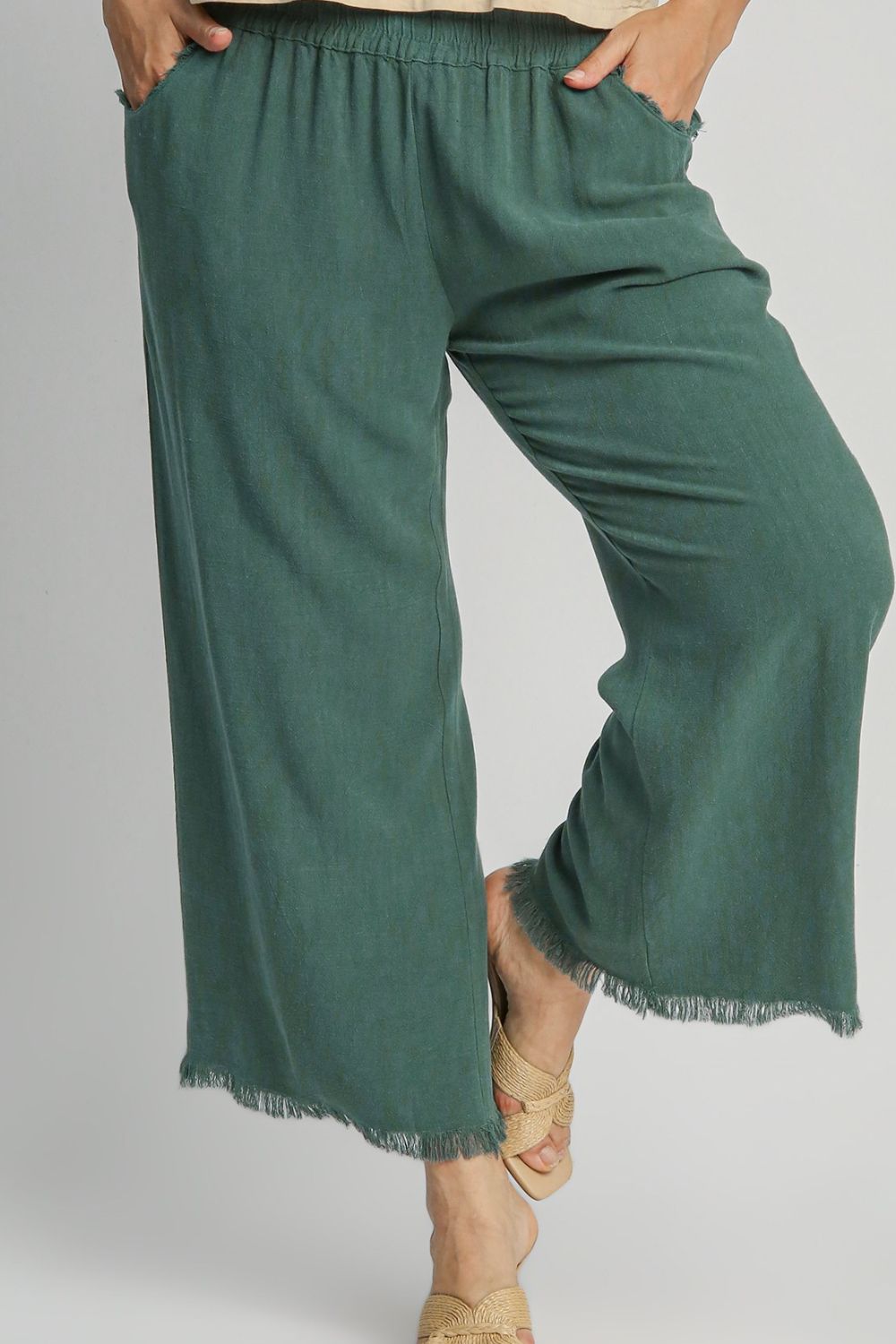 Linen blend wide-leg pants featuring an elastic waistband, breathable fabric, and functional side pockets for a chic and comfortable look.