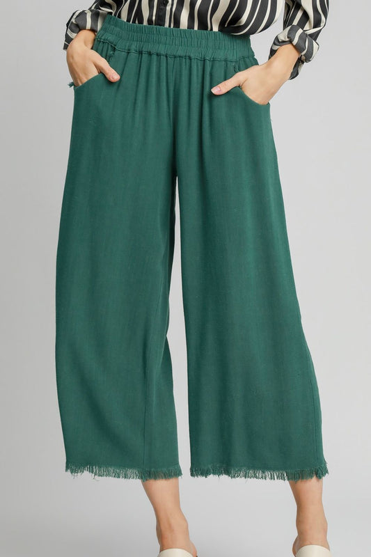 Linen blend wide-leg pants featuring an elastic waistband, breathable fabric, and functional side pockets for a chic and comfortable look.