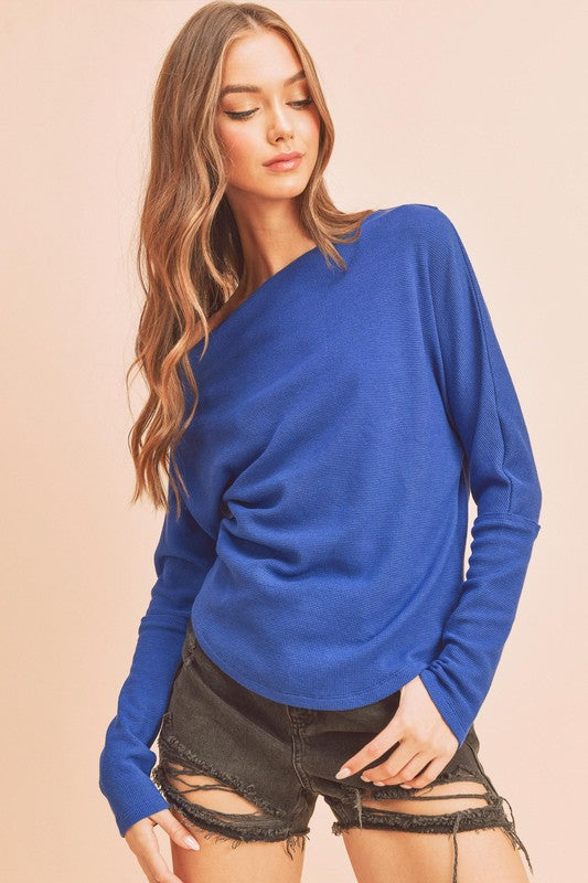 Asymmetrical one-shoulder long sleeve knit top with a modern, stylish design. Perfect for casual and dressy occasions.