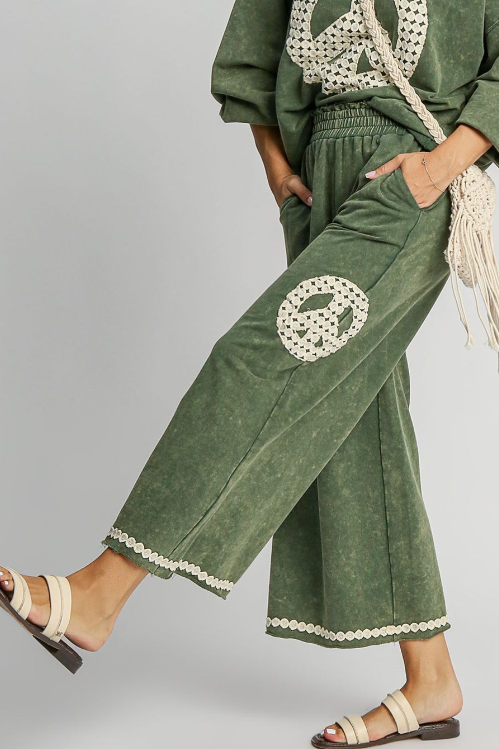 Chic mineral wash wide-leg pants with lace applique detailing and practical pockets for a stylish, boho-inspired look.