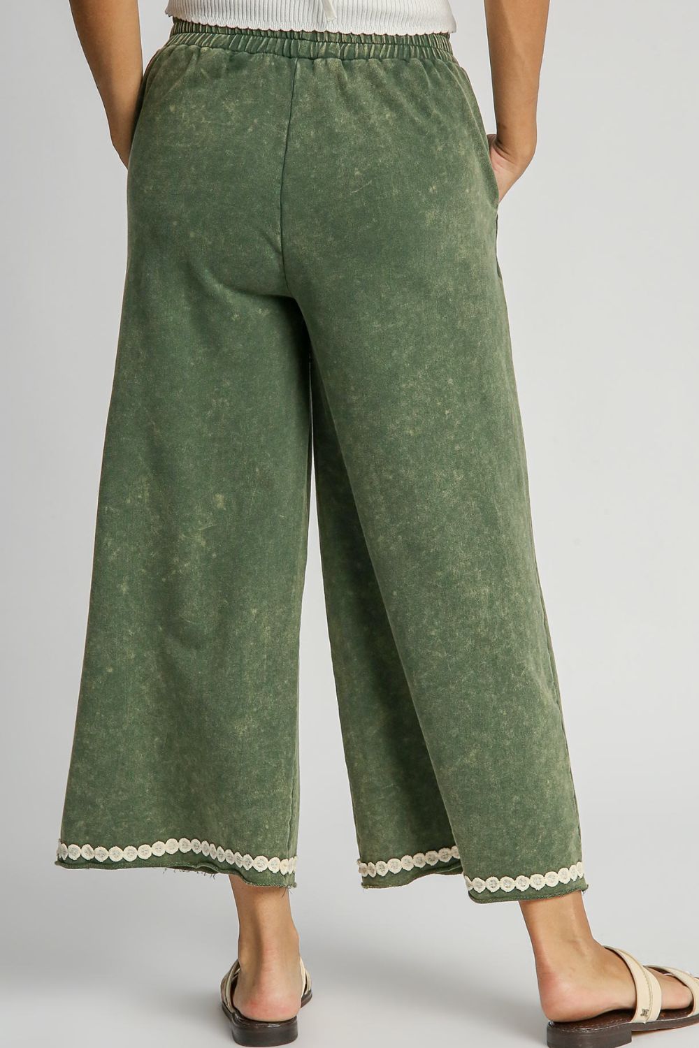 Chic mineral wash wide-leg pants with lace applique detailing and practical pockets for a stylish, boho-inspired look.