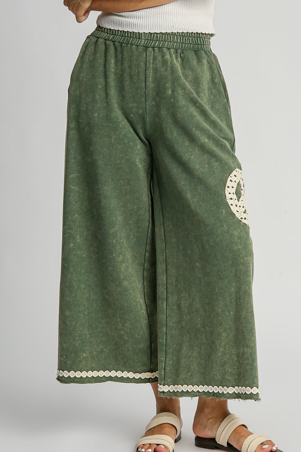 Chic mineral wash wide-leg pants with lace applique detailing and practical pockets for a stylish, boho-inspired look.