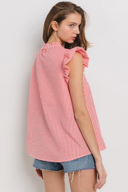 Chic plaid blouse with a flattering notched neckline and ruffled cap sleeves, perfect for a stylish and versatile look.