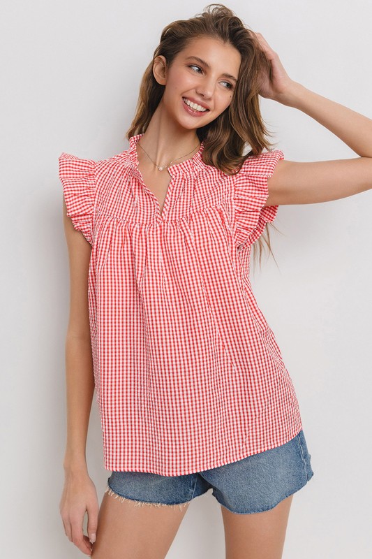 Chic plaid blouse with a flattering notched neckline and ruffled cap sleeves, perfect for a stylish and versatile look.