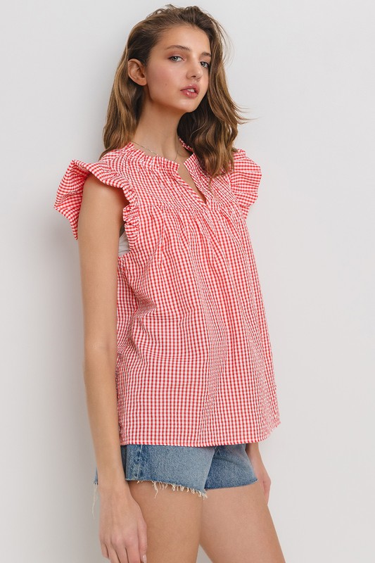 Chic plaid blouse with a flattering notched neckline and ruffled cap sleeves, perfect for a stylish and versatile look.