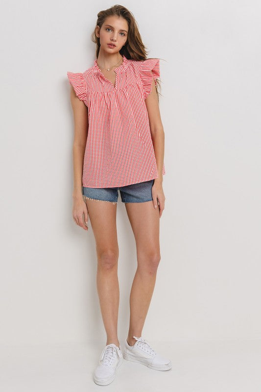 Chic plaid blouse with a flattering notched neckline and ruffled cap sleeves, perfect for a stylish and versatile look.