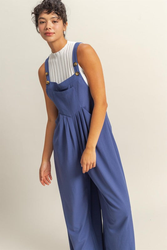 Chic pleated front pocket wide strap overalls with a relaxed and comfortable fit, perfect for casual styling.