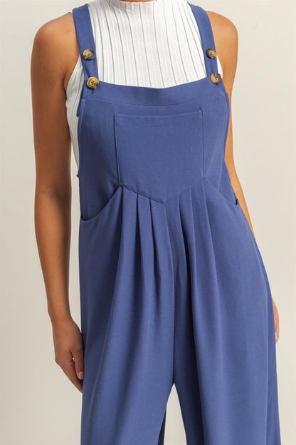 Chic pleated front pocket wide strap overalls with a relaxed and comfortable fit, perfect for casual styling.