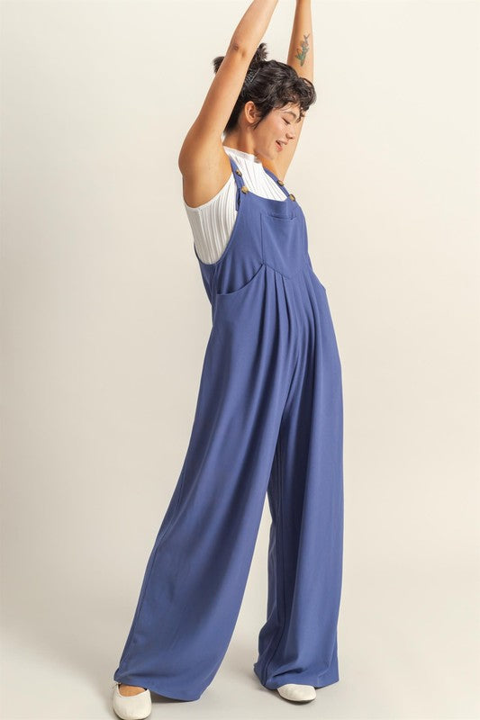 Chic pleated front pocket wide strap overalls with a relaxed and comfortable fit, perfect for casual styling.