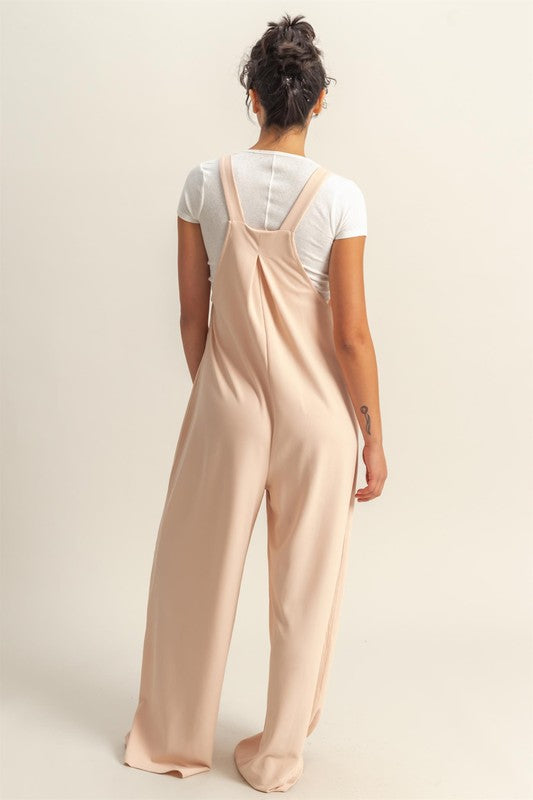 Trendy wide strap overalls with pleated details and front pockets for a stylish and comfortable look.