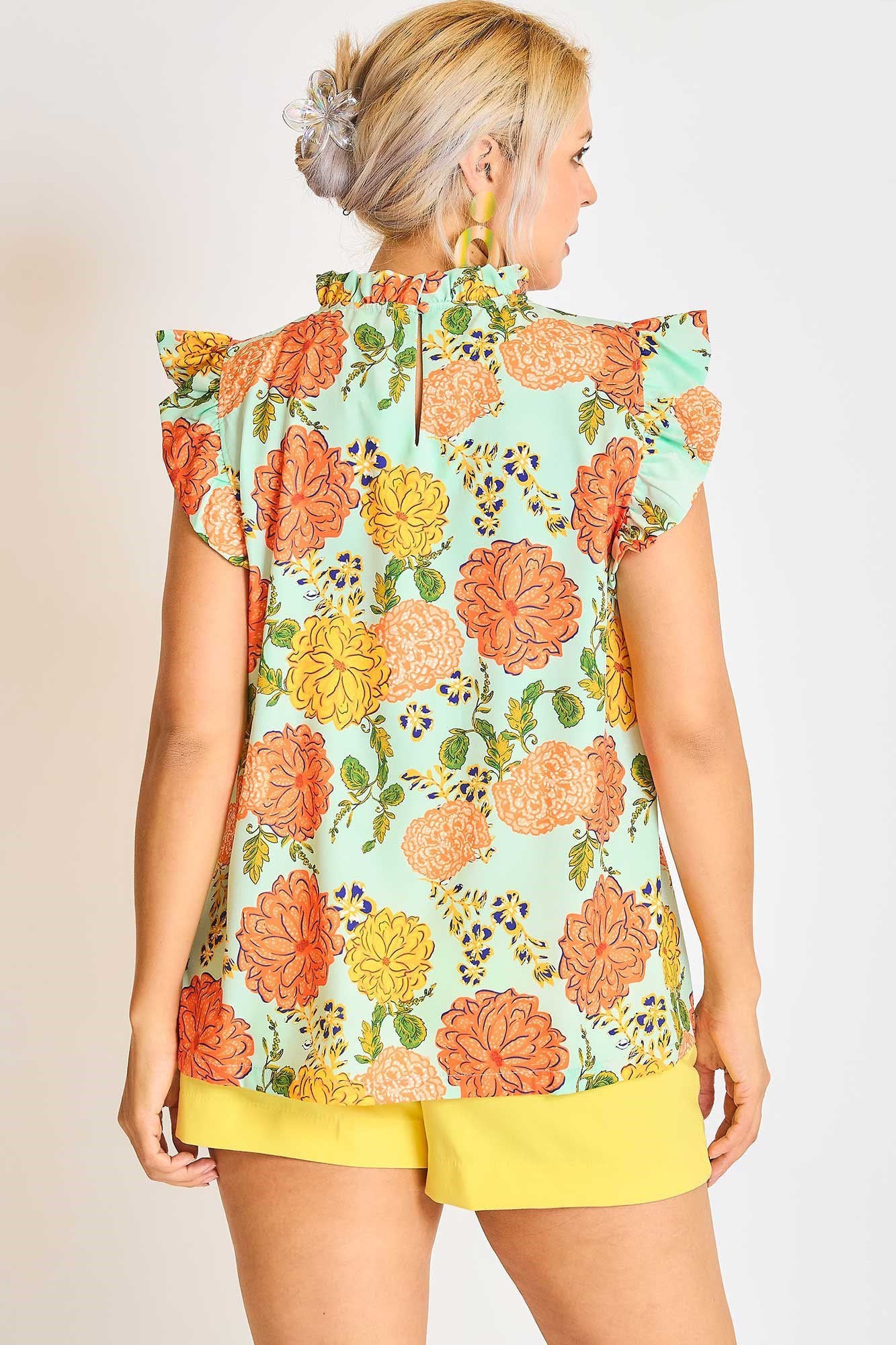 Elegant plus size floral print blouse with ruffled cap sleeves, perfect for a feminine and stylish look.