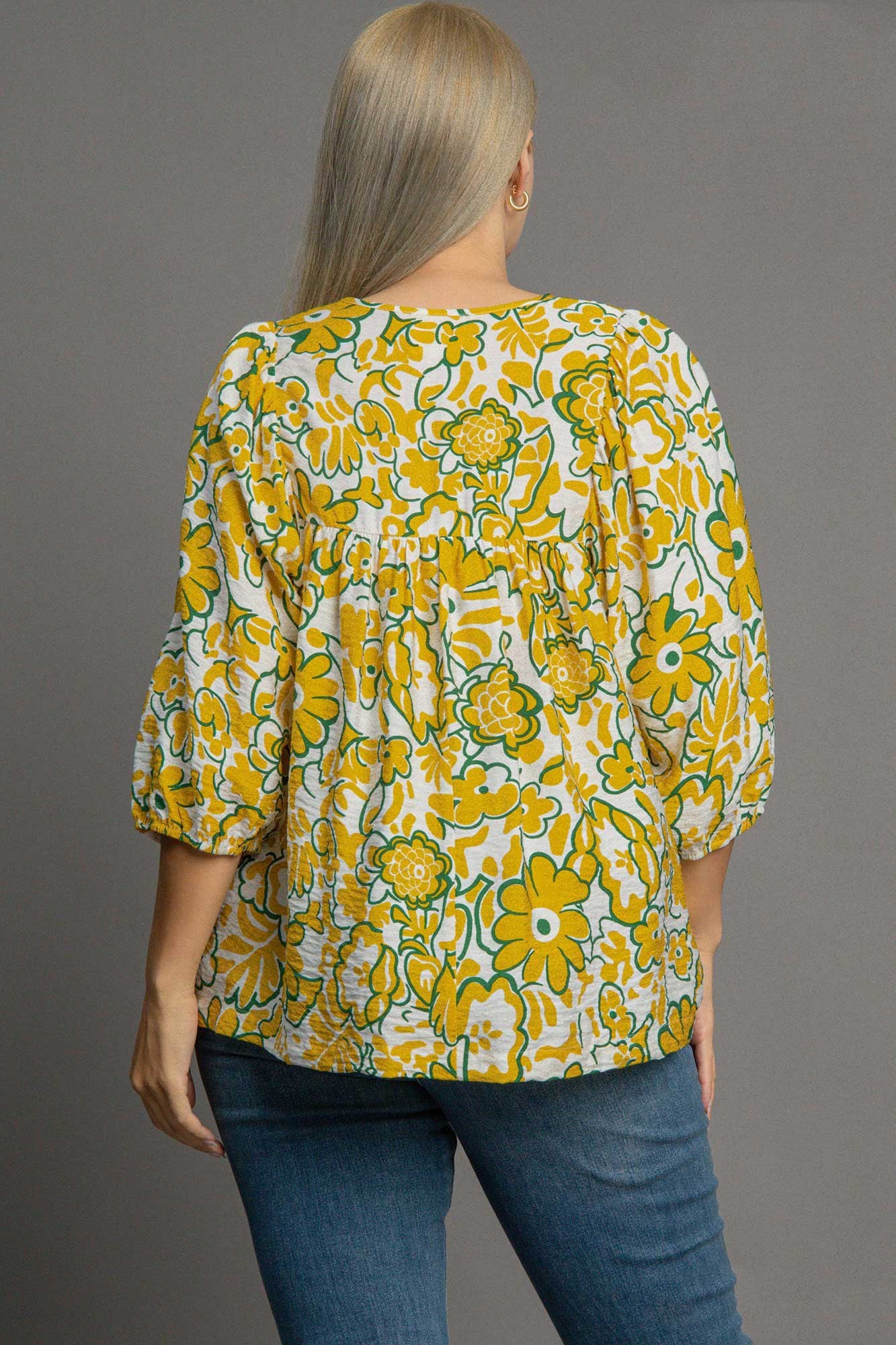 Plus size smocked floral print blouse with a tie neck design, perfect for a romantic and flattering everyday look.