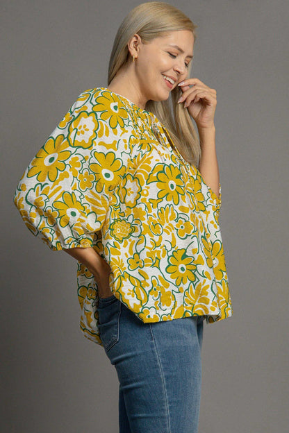 Plus size smocked floral print blouse with a tie neck design, perfect for a romantic and flattering everyday look.