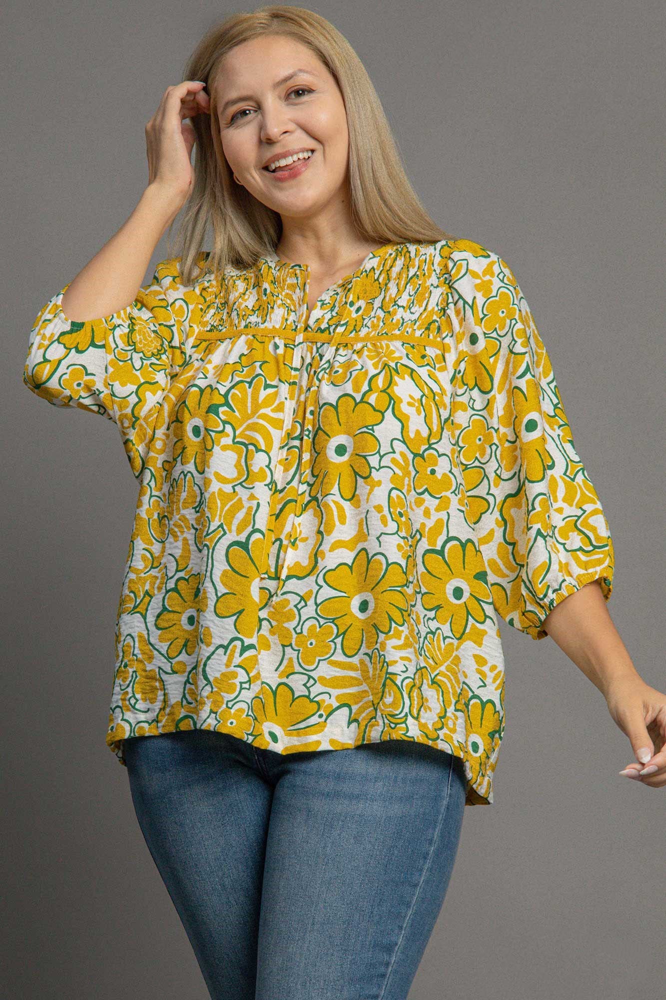 Plus size smocked floral print blouse with a tie neck design, perfect for a romantic and flattering everyday look.