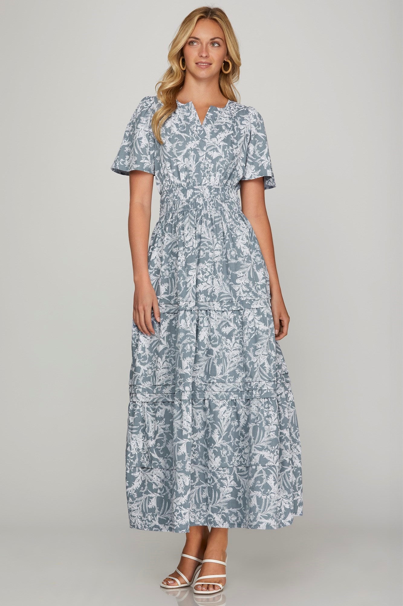 Flowy printed notched woven tiered pintuck maxi dress with a flattering silhouette and side pockets.