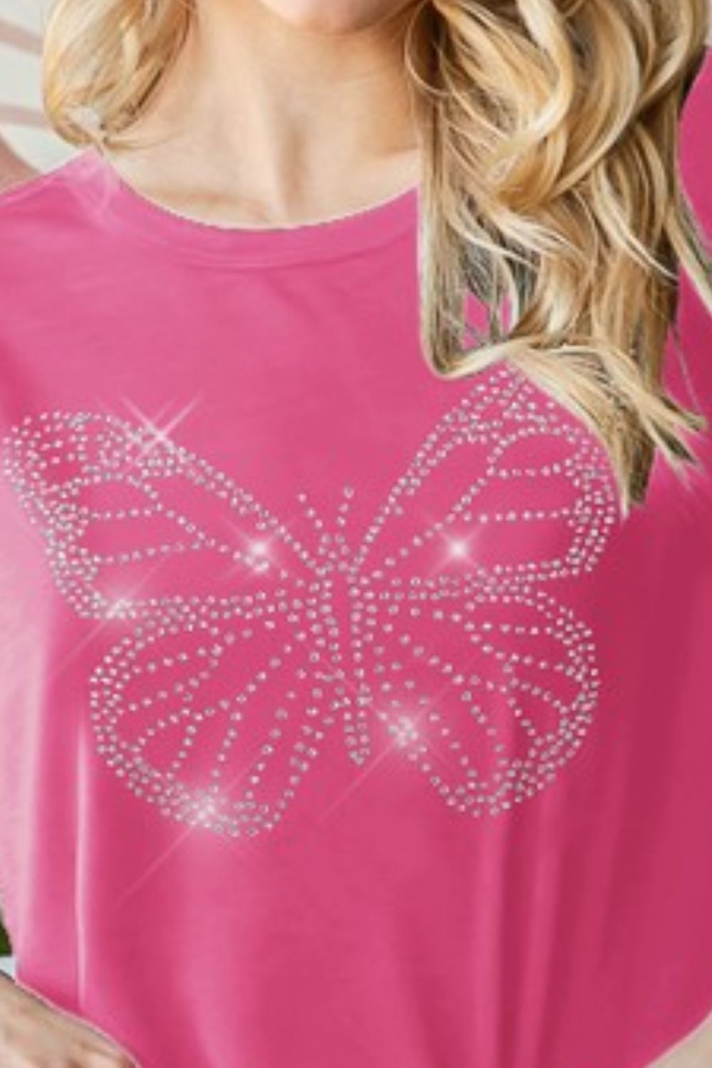 Stylish round neck t-shirt featuring a dazzling rhinestone butterfly design for a chic & casual look.