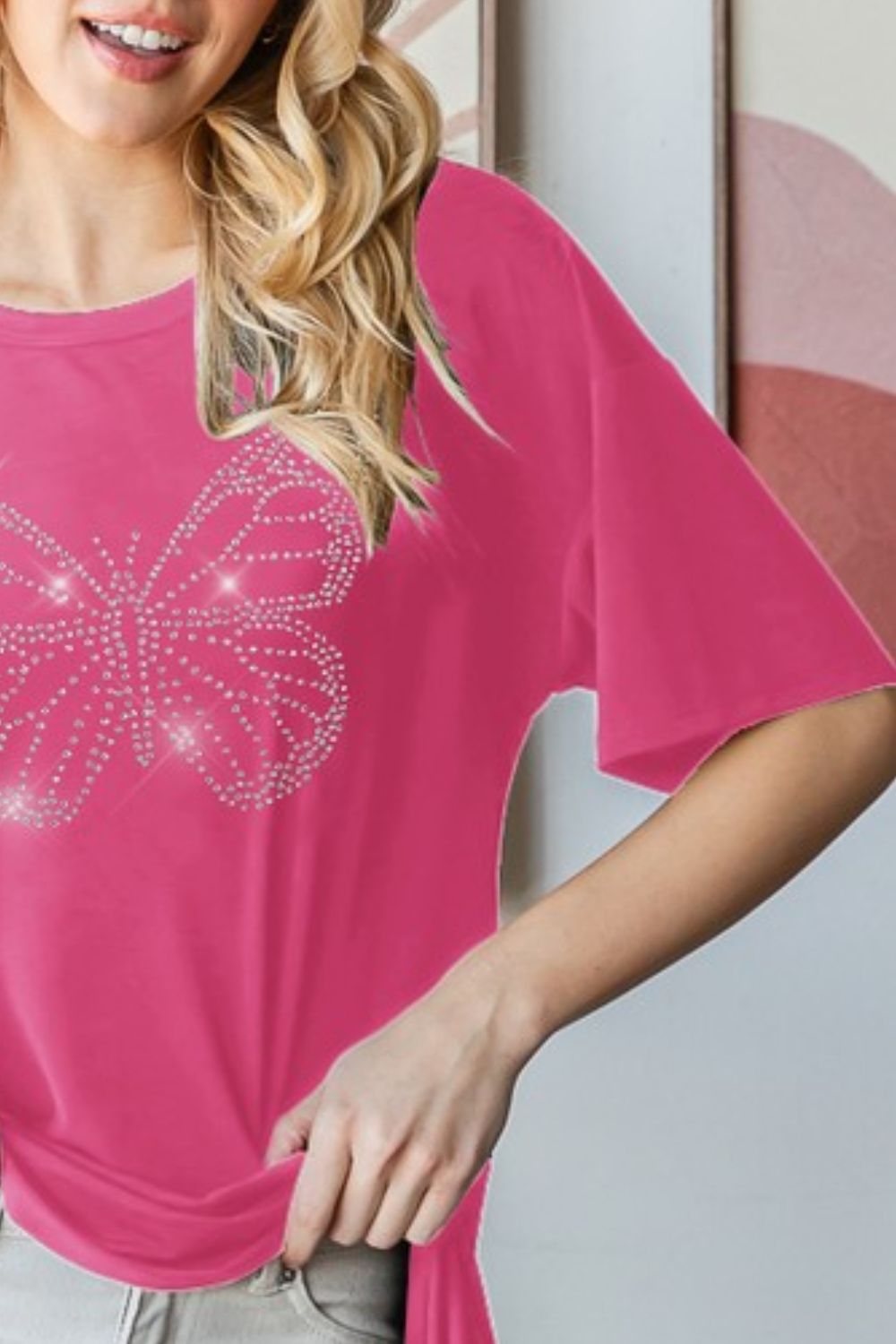 Stylish round neck t-shirt featuring a dazzling rhinestone butterfly design for a chic & casual look.