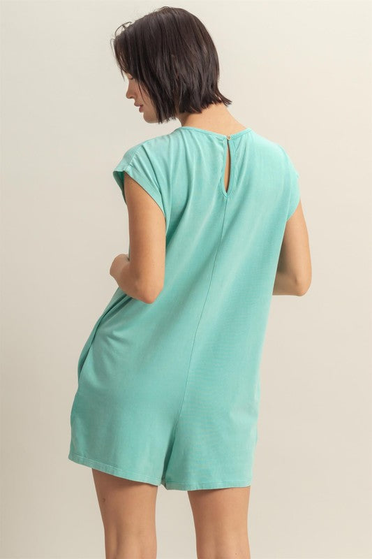 Casual and breezy romper with a round neck, cap sleeves, and a relaxed fit, perfect for summer wear.