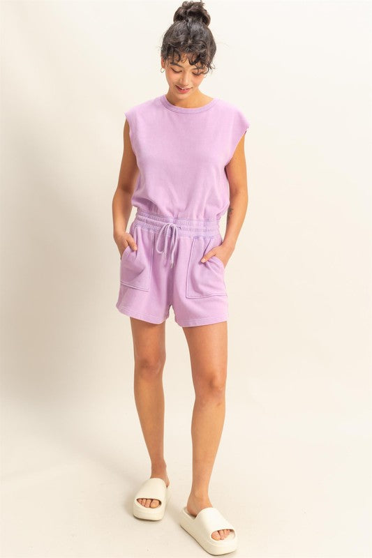 Chic round neck cap sleeve romper with drawstring waist, perfect for casual & laid-back occasions.