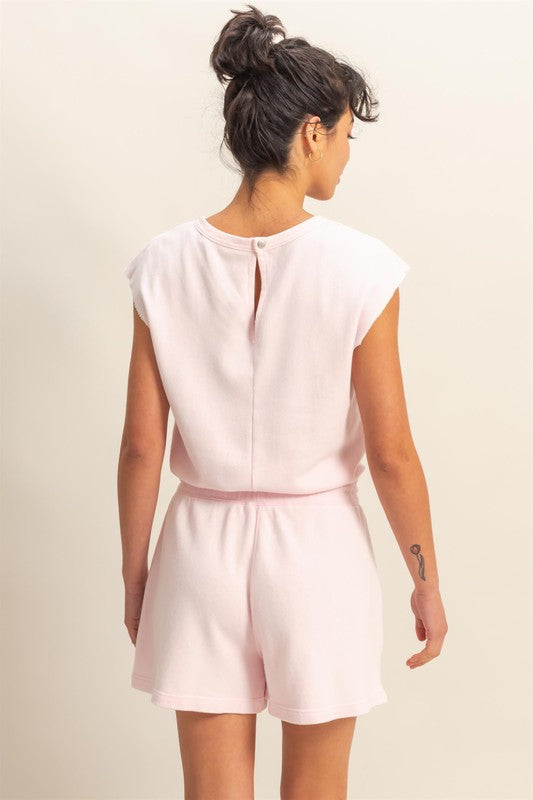 Casual round neck cap sleeve drawstring waist romper with pockets and a relaxed fit.