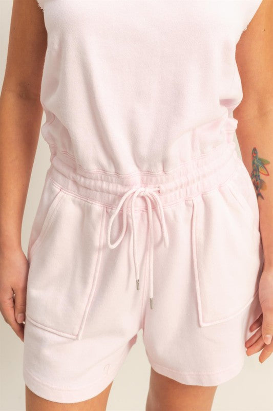 Casual round neck cap sleeve drawstring waist romper with pockets and a relaxed fit.