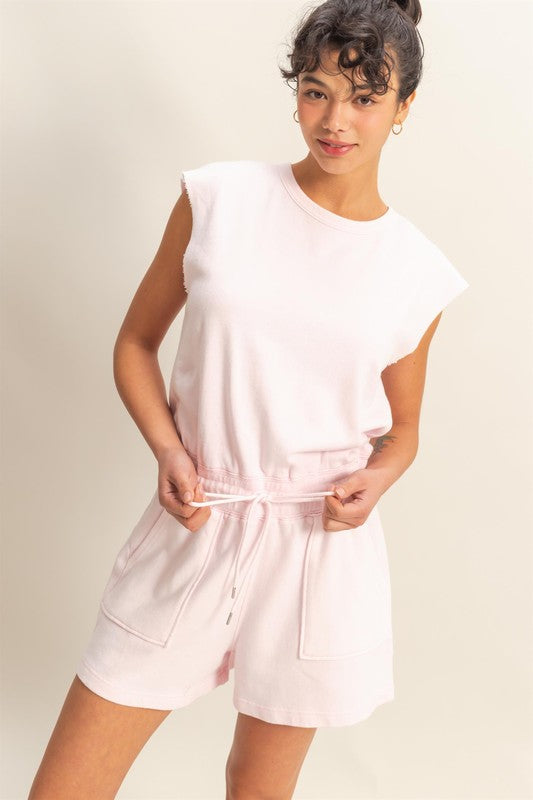 Casual round neck cap sleeve drawstring waist romper with pockets and a relaxed fit.