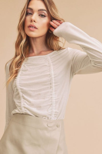 Flattering ruched front round neck long sleeve t-shirt in soft fabric, offering a stylish and comfortable fit for everyday wear.