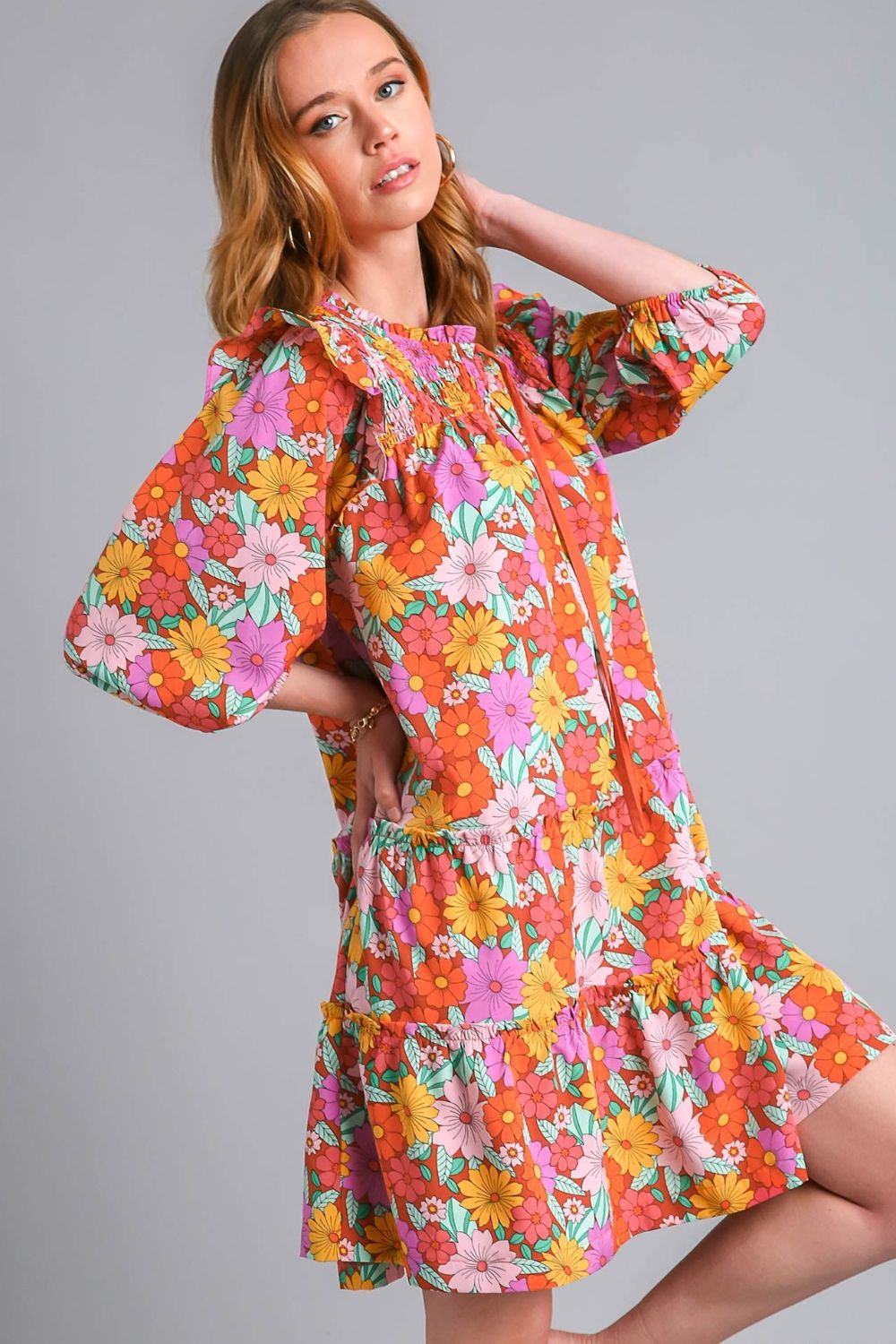 Elegant ruffled flower print tie neck tiered dress with a feminine and flowy silhouette.