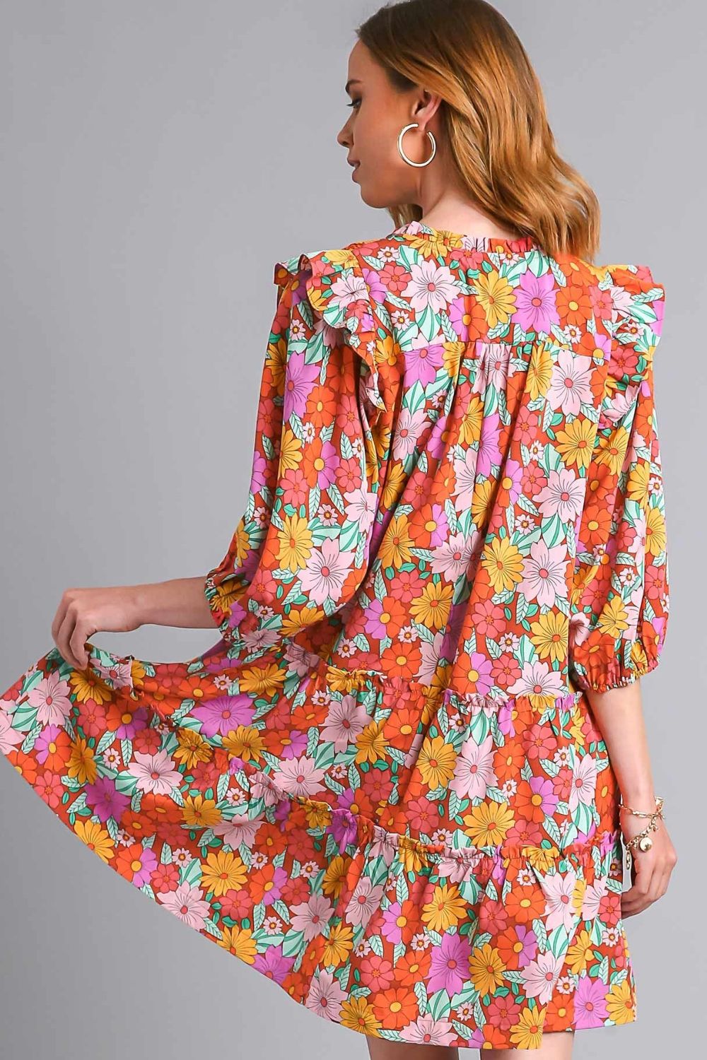 Elegant ruffled flower print tie neck tiered dress with a feminine and flowy silhouette.