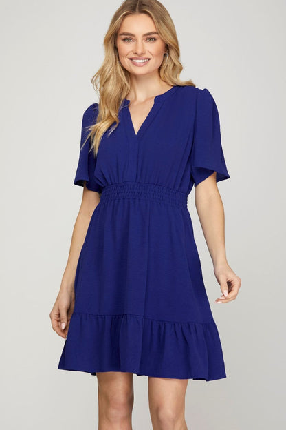 Chic ruffled hem notched flutter sleeve mini dress with a flattering smocked waist and romantic design.