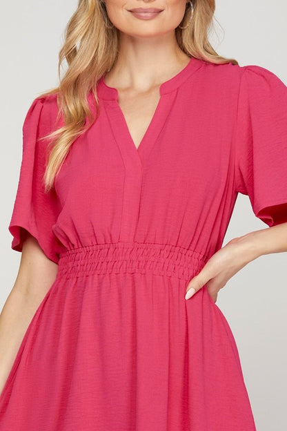 Chic ruffled hem mini dress with notched flutter sleeves, designed for a feminine & playful look.