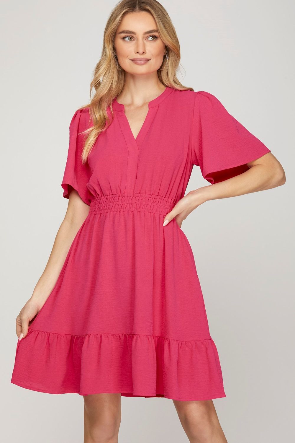 Chic ruffled hem mini dress with notched flutter sleeves, designed for a feminine & playful look.