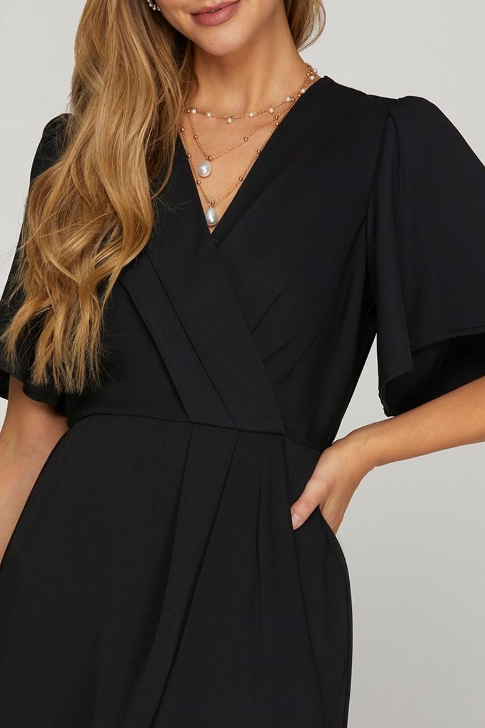 Chic ruffled surplice short flutter sleeve mini dress with a flattering neckline and playful ruffled details.