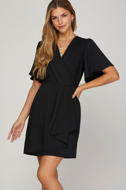 Chic ruffled surplice short flutter sleeve mini dress with a flattering neckline and playful ruffled details.