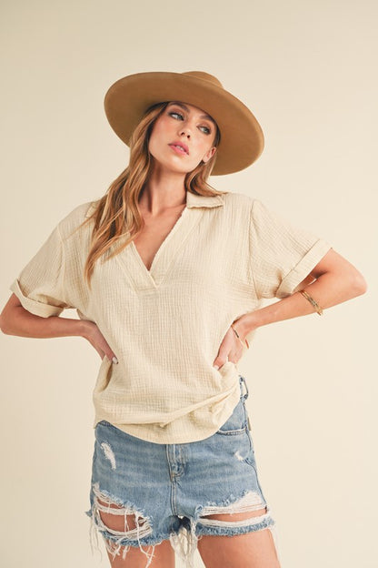 Stylish short sleeve cotton gauze blouse with a Johnny collar and side slits, perfect for a lightweight and breezy look.