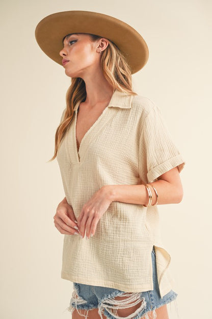 Stylish short sleeve cotton gauze blouse with a Johnny collar and side slits, perfect for a lightweight and breezy look.