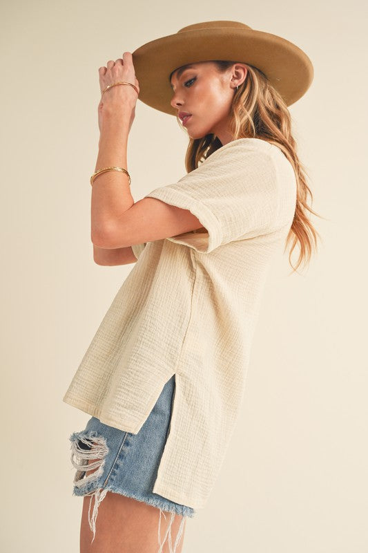 Stylish short sleeve cotton gauze blouse with a Johnny collar and side slits, perfect for a lightweight and breezy look.