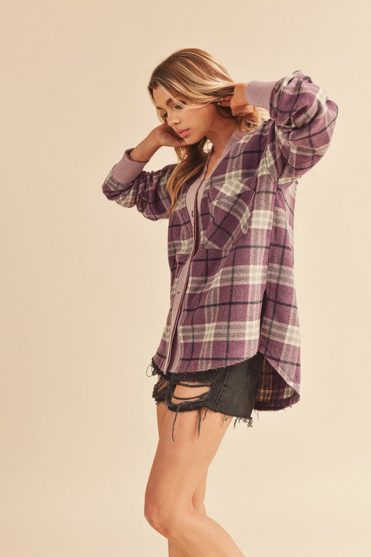 Cozy plaid button-down jacket with side slits and patch pockets for a stylish layered look.