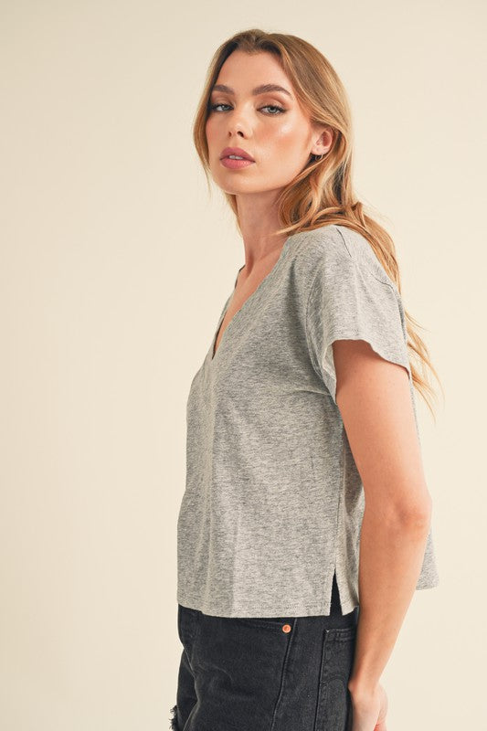 Modern V-neck cropped t-shirt with stylish side slits, perfect for casual and trendy outfits.