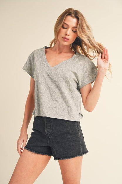 Modern V-neck cropped t-shirt with stylish side slits, perfect for casual and trendy outfits.