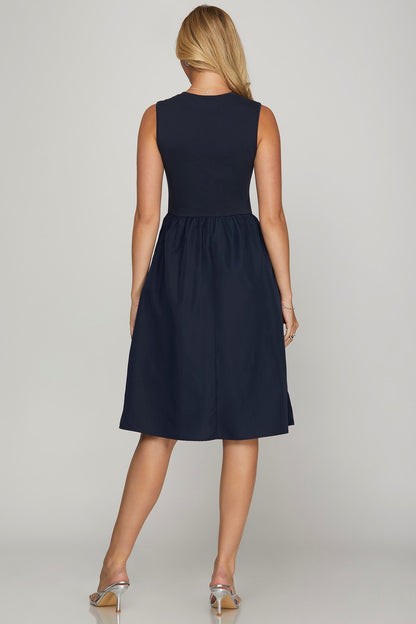 Chic sleeveless poplin midi dress with pockets, featuring a flattering A-line silhouette for effortless summer style.