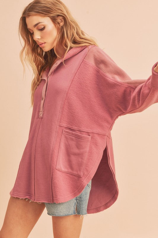 Trendy slit half snap oversize hoodie with a relaxed fit, side slits, and soft cotton-blend fabric. Perfect for casual wear.