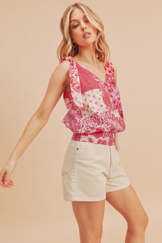 Chic printed surplice tank with a smocked hem, perfect for stylish and flattering summer outfits.